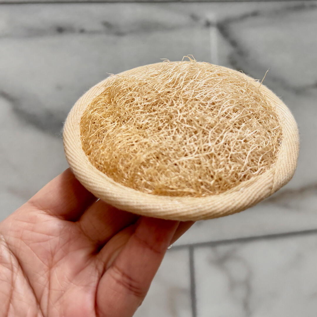 A hand holding a massage pad